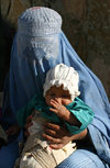 Afghanistan - Herat province - mother and child, both tradionally dressed - burka - photo by E.Andersen