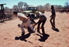 Australia - Cattle Station (NT): stockmen struggling with a cow - photo by  Picture Tasmania/Steve Lovegrove