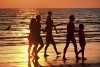 Australia - Northern Territory: family walking along the beach - sunset - photo by  Picture Tasmania/Steve Lovegrove