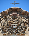 La Paz, Bolivia: Franciscan Order coat of arms on the faade of San Francisco church - cross with two arms crossing each other, one arm is that of Jesus Christ, the other is of St. Francis of Assisi - Orders of Friars Minor - photo by M.Torres