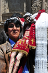 La Paz, Bolivia: man outside San Francisco church, holding with large crucifix, after thanking God for a granted request - Paceo - photo by M.Torres