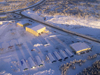 Northwest Territories, Canada: frozen aerodrome and hangars seen from the air - long shadows - photo by Air West Coast