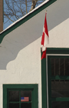 Canada / Kanada - Saskatchewan: flag hanging in doorway - photo by M.Duffy