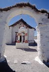 Lauca National Park, Arica and Parinacota region, Chile: beautiful 17th century adobe church in the village of Parinacota - whitewashed entrance arch - Norte Grande - photo by C.Lovell