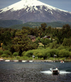 Araucana Region, Chile - Lake Villarica: boat and view of Villarica volcano, Villarica NP - photo by Y.Baby
