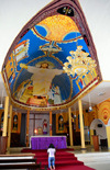 Brazzaville, Congo: altar of Cathedral of the Sacred Heart and the dramatic Christ fresco above it - woman praying -  Cathdrale du Sacr Cur / Cathdrale Saint Firmin (1892) - Quartier de l'Aiglon - photo by M.Torres