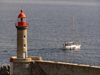 Corsica - Bastia: lighthouse and boat leaving port - photo by J.Kaman