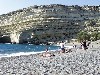 Crete - Matala (Irakleion prefecture): topless on the beach - caves on the cliff (photo by Alex Dnieprowsky)