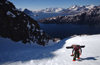 Greenland, Apussuit: snowboarder with heavy load climbing steep snow slope - photo by S.Egeberg