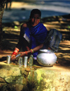 Orissa, India: a girl sells cow milk at a road crossing - photo by E.Petitalot