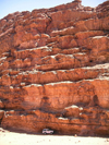 Jordan - Wadi Rum - Aqaba governorate: Land Cruiser hiding under a red cliff - photo by R.Wallace