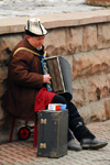 Kazakhstan, Almaty: Arbat - Zhybek-Zholy, or Silk road street - accordion player - street musician with Kazakh hat - photo by M.Torres