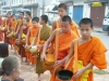 Laos - Luang Prabang: monks collecting food donations - people giving alms - photo by P.Artus