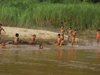 Laos - Mekong River: kids enjoying the river on the muddy waters - photo by M.Samper