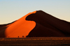 Namib Desert - Sossusvlei, Hardap region, Namibia, Africa: Apricot colored sand dune at sunrise - photo by B.Cain