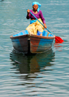 Pokhara, Nepal: old woman paddling on Phewa lake - photo by E.Petitalot