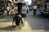 Kathmandu, Nepal: using a wheelchair on a busy street - photo by W.Allgwer