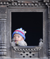 Nepal - Langtang region - baby looking outside - photo by E.Petitalot