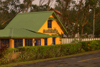 Panama - Cerro Azul: yellow house with green roof bathed in golden light - photo by H.Olarte