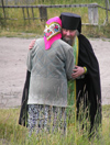 Russia - Solovetsky Islands: Russian Orthodox Priest - comforting a member of the flock - photo by J.Kaman