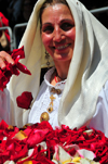 Cagliari, Sardinia / Sardegna / Sardigna: Feast of Sant'Efisio / Sagra di Sant'Efisio - 'Sa Ramadura' ritual - lady preparing a shower of rose petals - photo by M.Torres