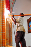 Kampala, Uganda: worker welding metal among a burst of sparks - St. Mary's Catholic Cathedral, Rubaga Cathedral, Rubaga hill - Metropolitan Archdiocese of Kampala - photo by M.Torres
