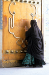 Iran - Shiraz: Shah-e-Cheragh mausoleum - tomb of Mir Sayyed Ahmad and Mir Muhammad, brothers of the eight Iman, Reza - woman kissing the door - photo by W.Allgower