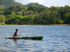 Panama - Chagres National Park: Embera Wounaan paddles on a dugout canoe. Modern day natives wear occidental clothes when traveling to the city - photo by H.Olarte